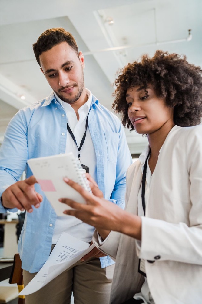 Two colleagues reviewing a project plan together